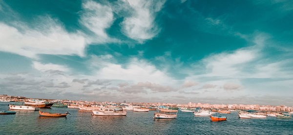 Boats moored in sea against sky