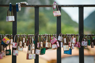 Close-up of padlocks hanging on railings