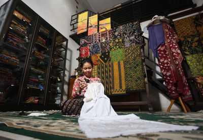Low angle view of woman working in textile workshop