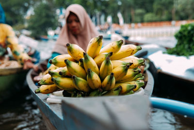 Woman eating fruit on plant