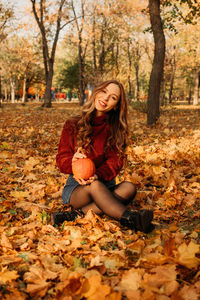 Portrait of smiling young woman in autumn