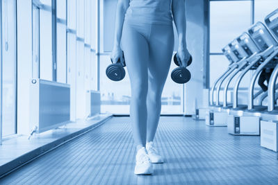 Low section of woman exercising in gym