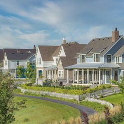 Houses by building against sky