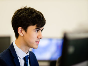 Close-up of young businessman working in office