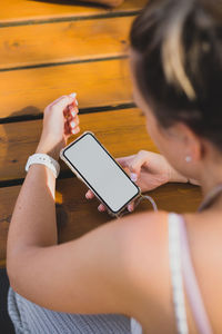 Midsection of woman using mobile phone