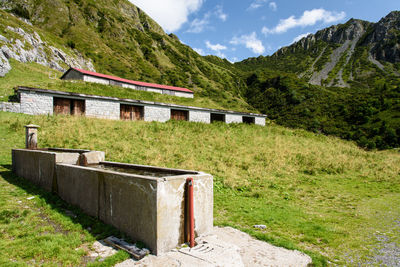 Built structure on landscape against mountains