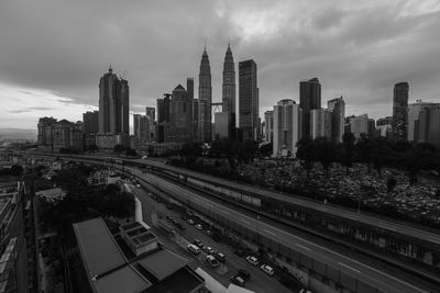 High angle view of road amidst buildings in city against sky