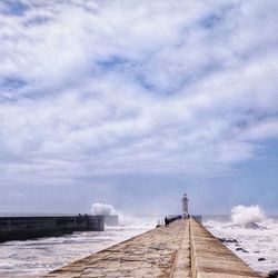 Pier over sea against sky