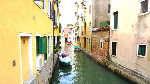 Canal and boats with ancient architecture in venice, italy