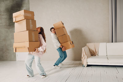 Low section of woman with suitcase on floor