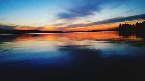 Scenic view of lake at sunset