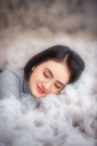 Close-up of young woman amidst cotton