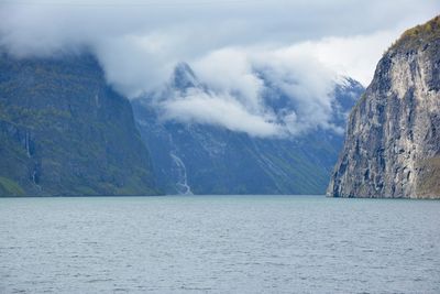 Scenic view of sea and mountains against sky