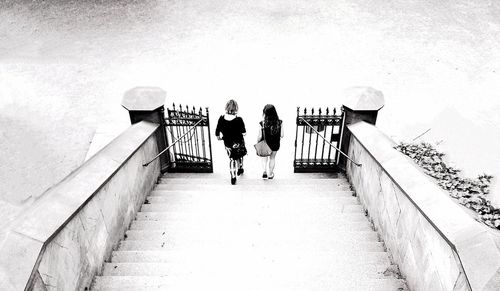 Full length of woman standing on railing