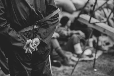 Midsection of man holding while standing outdoors