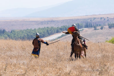 People riding motorcycle on field