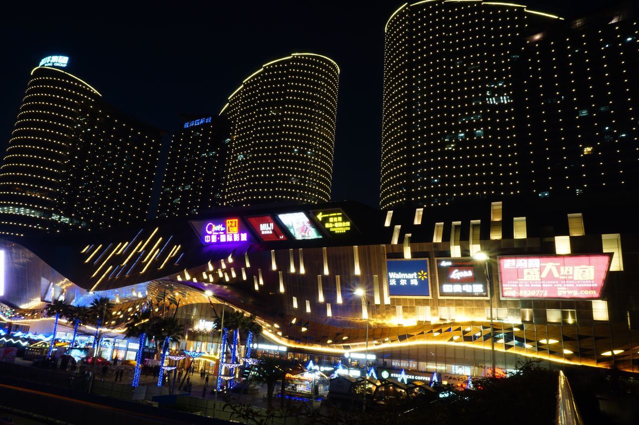 illuminated, night, architecture, built structure, building exterior, city, low angle view, travel destinations, modern, famous place, capital cities, lighting equipment, text, city life, sky, light - natural phenomenon, travel, international landmark, skyscraper, tourism