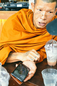 Portrait of smiling man sitting on table