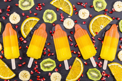 Directly above shot of popsicles and fruits on table