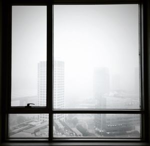 Cityscape against sky seen through window