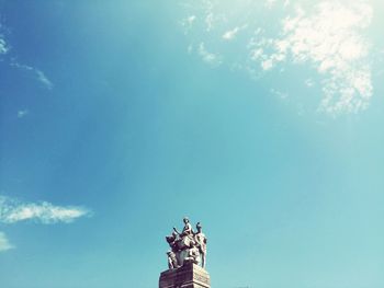Low angle view of statue against blue sky