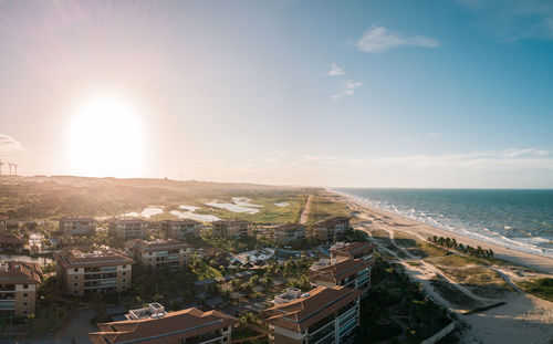 High angle view of buildings and sea against sky