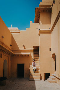 Man standing against building