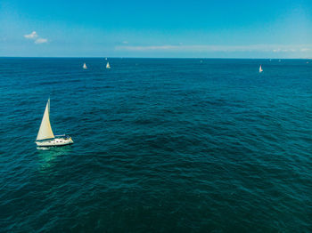 Sailboat sailing in sea against sky