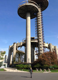 Silhouette of people in front of building against clear sky
