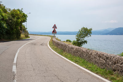 Road by sea against sky at lake garda italy