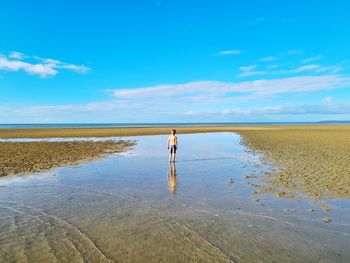 Lone boy on a deserted beach