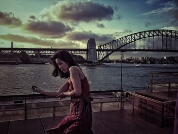 Man walking on bridge over river