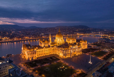 Budapest night skyline revealed hungarian parliament building and danube river from a drone point