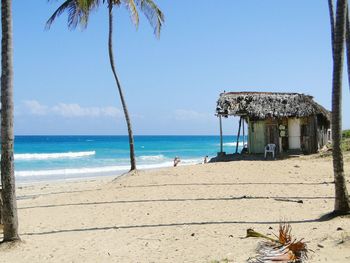 Hut at beach against sky