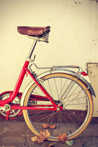 Bicycle leaning on wall