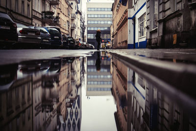 Surface level of person standing on wet city street during rainy season