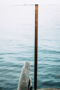 Close-up of wooden posts in sea