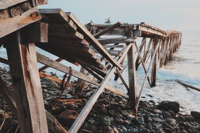 Built structure on beach against sky during winter