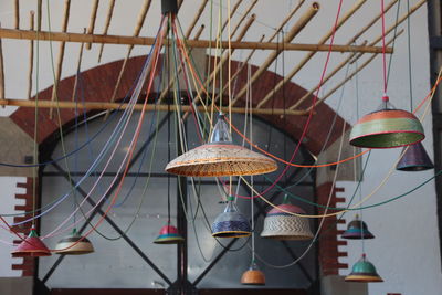 Low angle view of lighting equipment hanging on ceiling of building