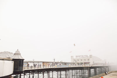 Brighton pier over sea against clear sky