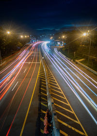 High angle view of light trails on highway at night