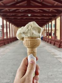 Close-up of hand holding ice cream cone