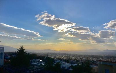 Aerial view of cityscape against sky at sunset