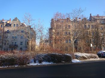 Buildings in city against sky during winter