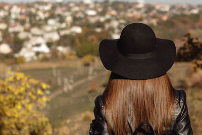 Rear view of woman wearing hat on sunny day