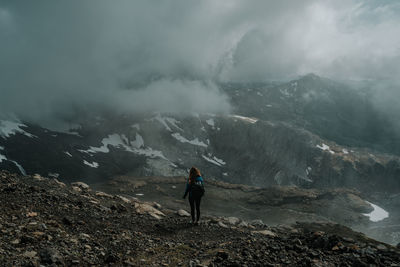 Woman standing in fog on mountain