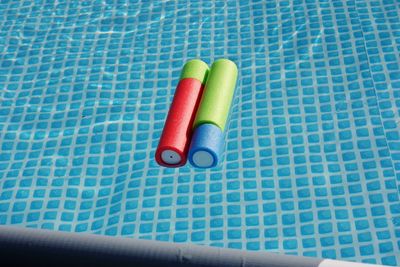 High angle view of multi colored pencils on swimming pool