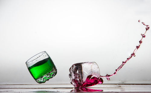 Close-up of glass over white background