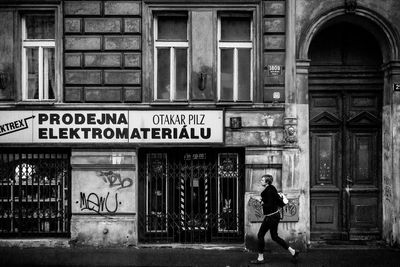 Full length of man standing by building