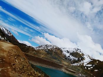 Tilt shot of snowcapped mountains against sky